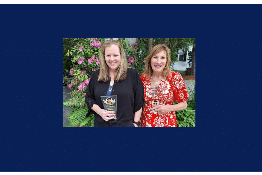 Two LuMind IDSC Employees pose holding the Collin Lis Humanitarian Award